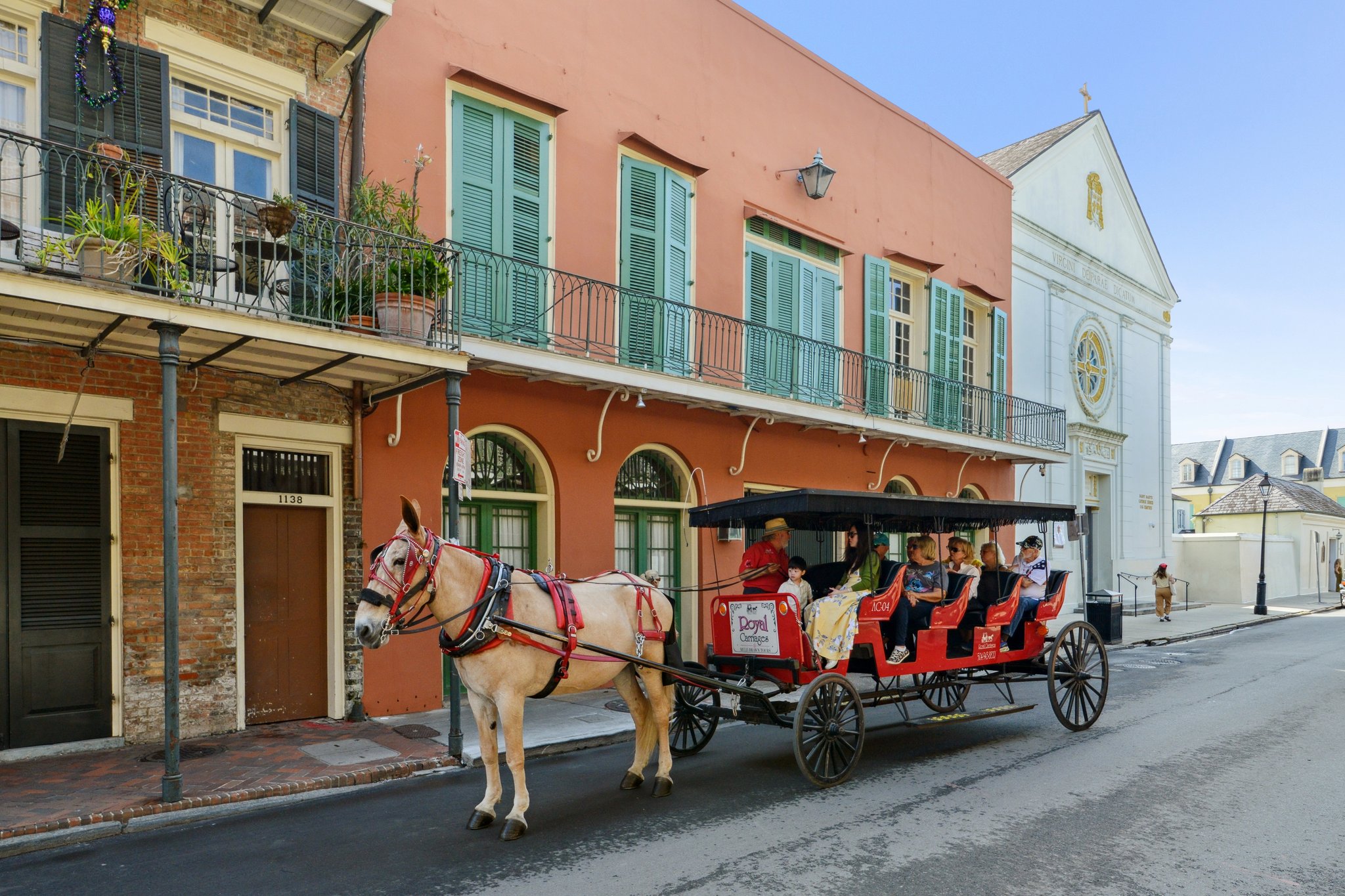 Historic French Quarter street in New Orleans with a horse-drawn carriage