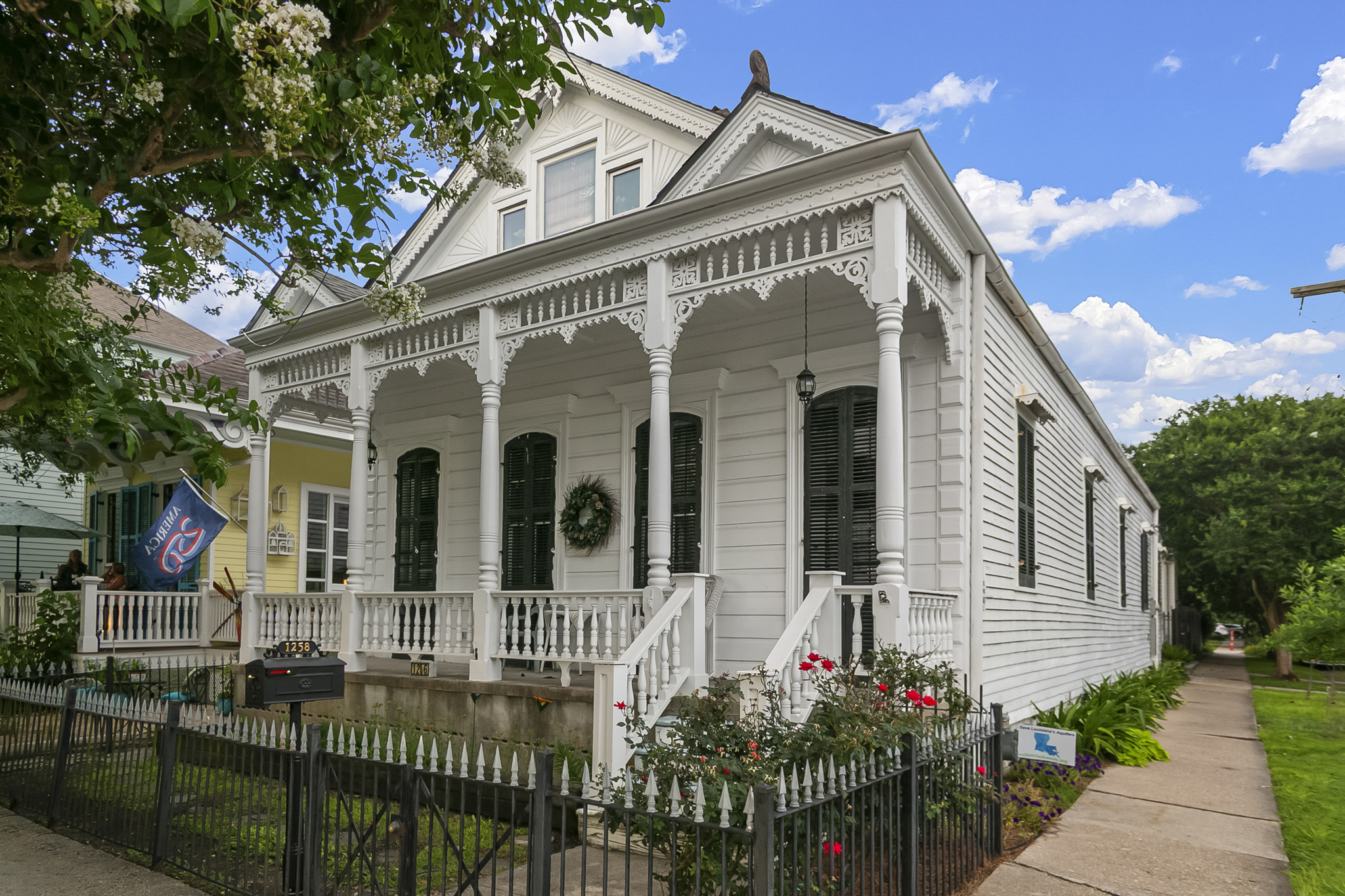 Historic white Victorian home with gingerbread trim in New Orleans